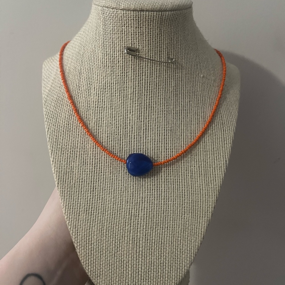 #14. Handmade Orange Beaded Necklace with Blue Pendant